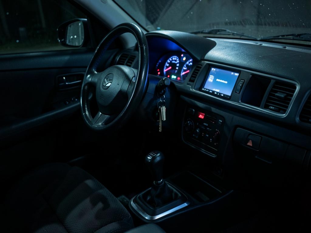 Right-hand drive imported vehicle interior at night with key in ignition